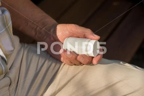 Male hand with pill bottle. Stock Photos