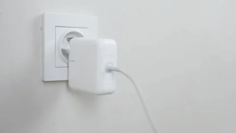 Male Hand Plugging and Unplugging Charger in Wall Socket Closeup Vidéo 335188652