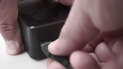 Male hand plugging USB cable into power bank | Portable charging concept Stock Footage 311918609
