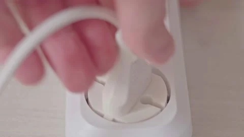 Male Hand Plugs In The Plug In Socket Electric Extension Cord And Turn On The Stock Footage 194080537