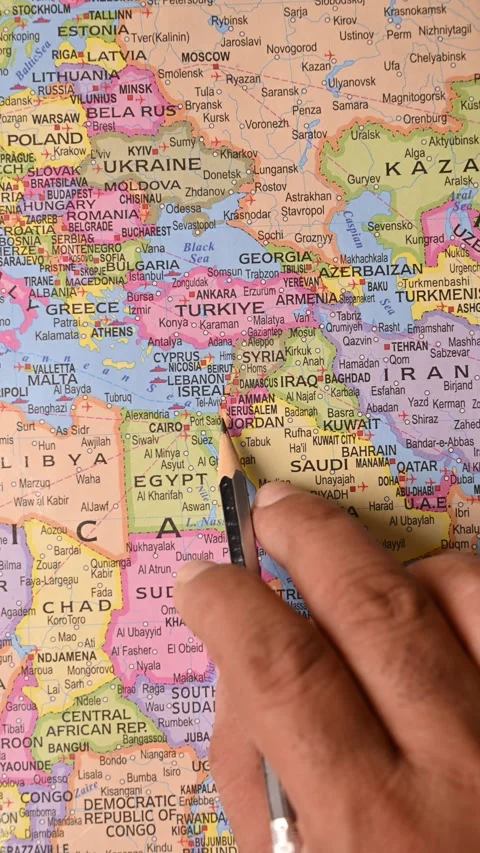 Male Hand Pointing Jerusalem on Map with Pencil – Top View, Vertical Footage Stock Footage 329356014