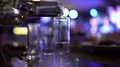Male hand pouring in huge shot of vodka, alcoholism issues, failed abstinence 4k or 4k+ Resolution