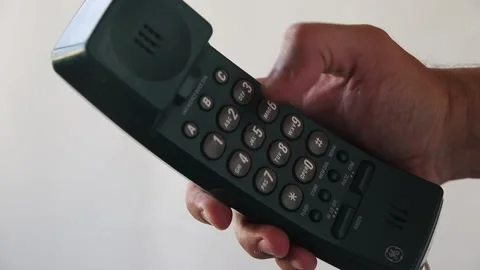 Male hand presses button 8 on GE landline push-button telephone Stock Footage 139511283