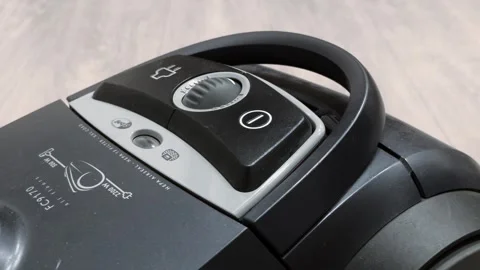 Male hand presses power button of bagged vacuum cleaner. Close up view control Stock Footage 339865285