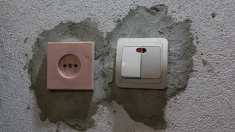 Male Hand Pressing Light Switch on Unfinished Wall During Renovation Stock Footage 335637503
