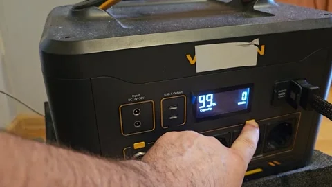 Male Hand Pressing the Power Button on a Portable Power Station Battery Backup Stock Footage 341852933