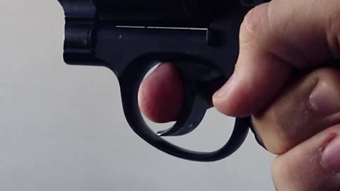 Male hand pulls the trigger of a revolver Stock Footage 146753230
