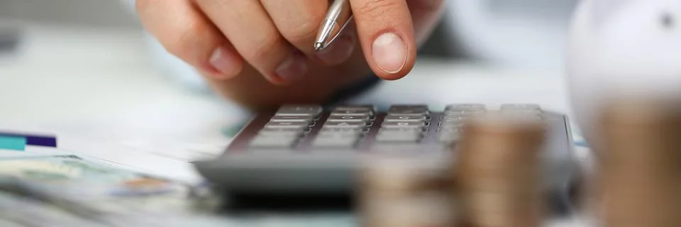 Male hand push key silver calculator is lying Fotos de archivo