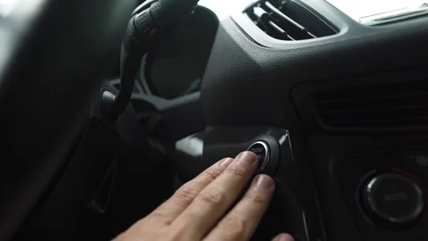Male hand pushes engine start stop button in a modern car interior Stock Footage 120528409