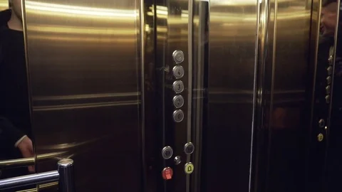 Male hand pushing the elevator button labeled with the number one. Front shot Stock Footage 72906332