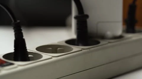 Male hand put Electric plug on multiple socket. Electrical equipment and Stock Footage 309448387