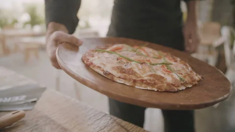 Male hand puts pizza on the table. Slow Motion Video Stock Footage 103243648