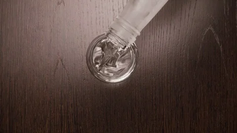 Male hand puts on the table a shot glass for vodka. top view Stock Footage 73798707