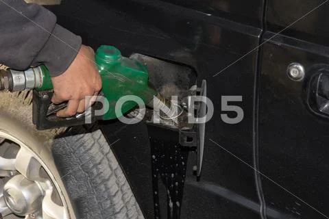 Male Hand Refilling The Car With Fuel On A Filling Station