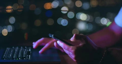 Male hand scrolling browsing on a smartphone at night time. Close-up of person Stock Footage 243586261