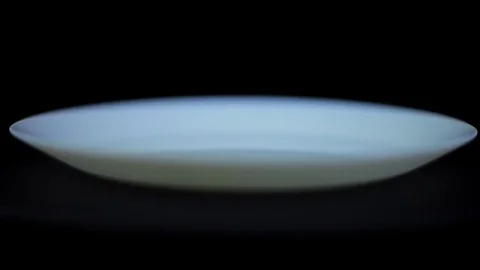 Male hand shows the - multitool next to a white empty plate Stock Footage 78626357