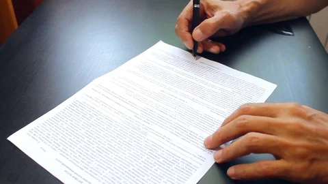 Male hand signs a document Stock Footage