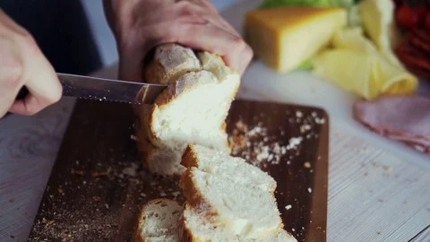 Male hand slicing bread, super slow motion Stock Footage 74150982