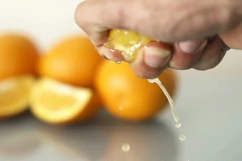 Male hand squeeze juicy orange NTSC Stock Footage