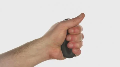 Male hand squeezing an expander on a white background Stock Footage 172369262