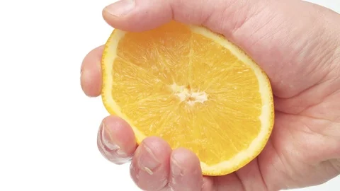 Male hand squeezing an orange Stock Footage 124114703