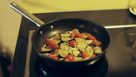 Male hand stirring vegetables in a pan. Fried tomatoes, onions, eggplant. Stock Footage 103663979