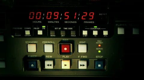 Male hand stops and ejects video tape from recorder - Editorial use. Stockbeeldmateriaal 327347