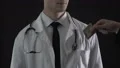 Male hand taking money doctor pocket, low paid physicians, health care reform HD Footage