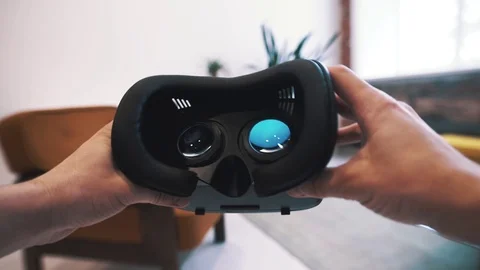 Male hand taking a virtual reality headset. Virtual reality mask Stock Footage 73569488