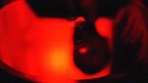 Male hand throwing bullet cases on the table isolated over bright red light Stock Footage 101548205