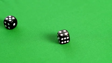 Male hand throwing double dice five and four on green background. Player rolling Stock Footage 140480322