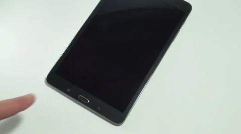 Male hand touching power button on the tablet computer Stock Footage 61203002