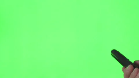 Male hand with TV remote control over green screen. Place for your advertisement Stock Footage 259451925