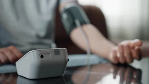 Male Hand Using Automatic Tonometer for Blood Pressure Check Stock Footage 312473413