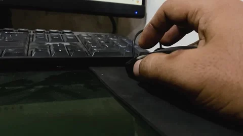 Male hand using a computer mouse and keyboard while working on a laptop. Stock Footage 293613368