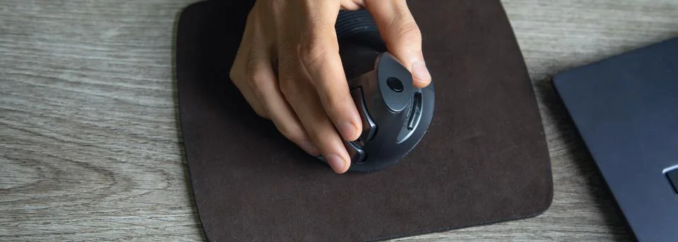 Male hand using computer mouse at home. Stock Photos