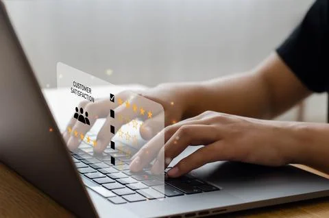 Male hand using computer Notebook with five-star pop-up icon for feedback, .. Stock Photos