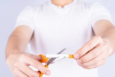 Male hand using scissors cutting cigarette. World no Tobacco and stop smoking Stock Photos
