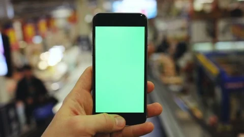 Male hand using smartphone with blank green screen on subway escalator in the Stock Footage 86696441