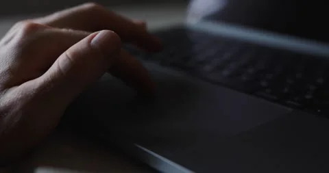 Male hand using a touchpad on a laptop. Video contains original audio. Stock Footage 321550257