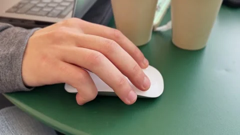 Male Hand Using White Wireless Mouse Outdoors at Cafe Table 스톡 동영상 324952802