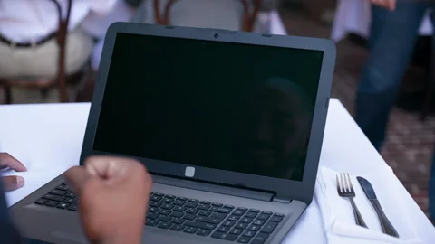 Male hand watching computer at lunch table  fist pump Stock Footage 298044681
