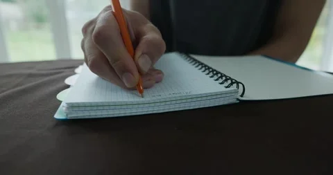 Male hand write notes in notebook 4K 10-bit 스톡 동영상 345258417