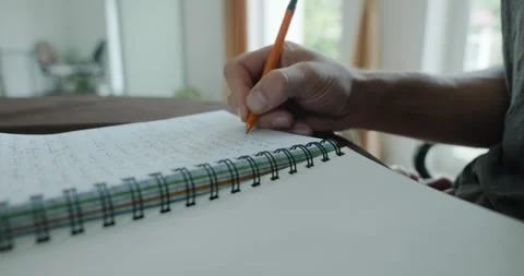 Male hand write notes in notebook 4K 10-bit 스톡 동영상 345258509