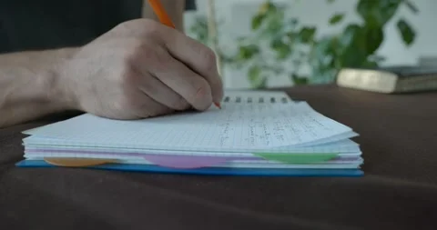 Male hand write notes in notebook 4K 10-bit 스톡 동영상 345258569