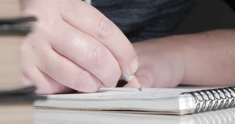 A male hand writing notes in notepad Stock Footage 145180073