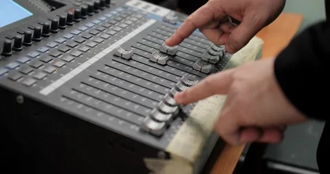 Male hands adjusting volume knobs on a studio soundboard, closeup shot 動画素材 146020994
