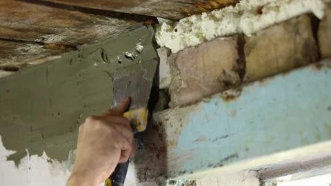 Male hands apply putty with a spatula Stock Footage 220634553