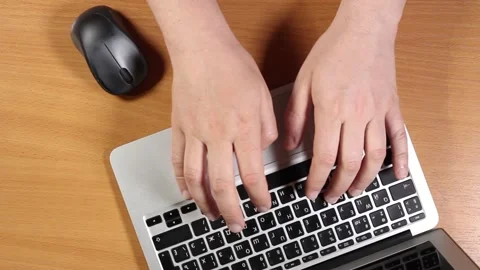Male hands are typing on a laptop. Top view Stock Footage 132954953