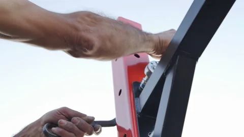 The male hands of the assembler assembler tighten the bolt and nut Stock Footage 197569290